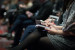 woman sitting in a meeting holding a piece of paper and a pen