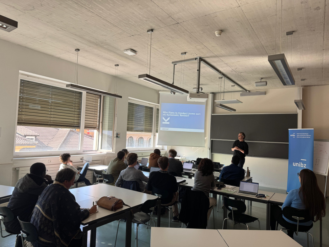 people attending a seminar and listening to the speaker