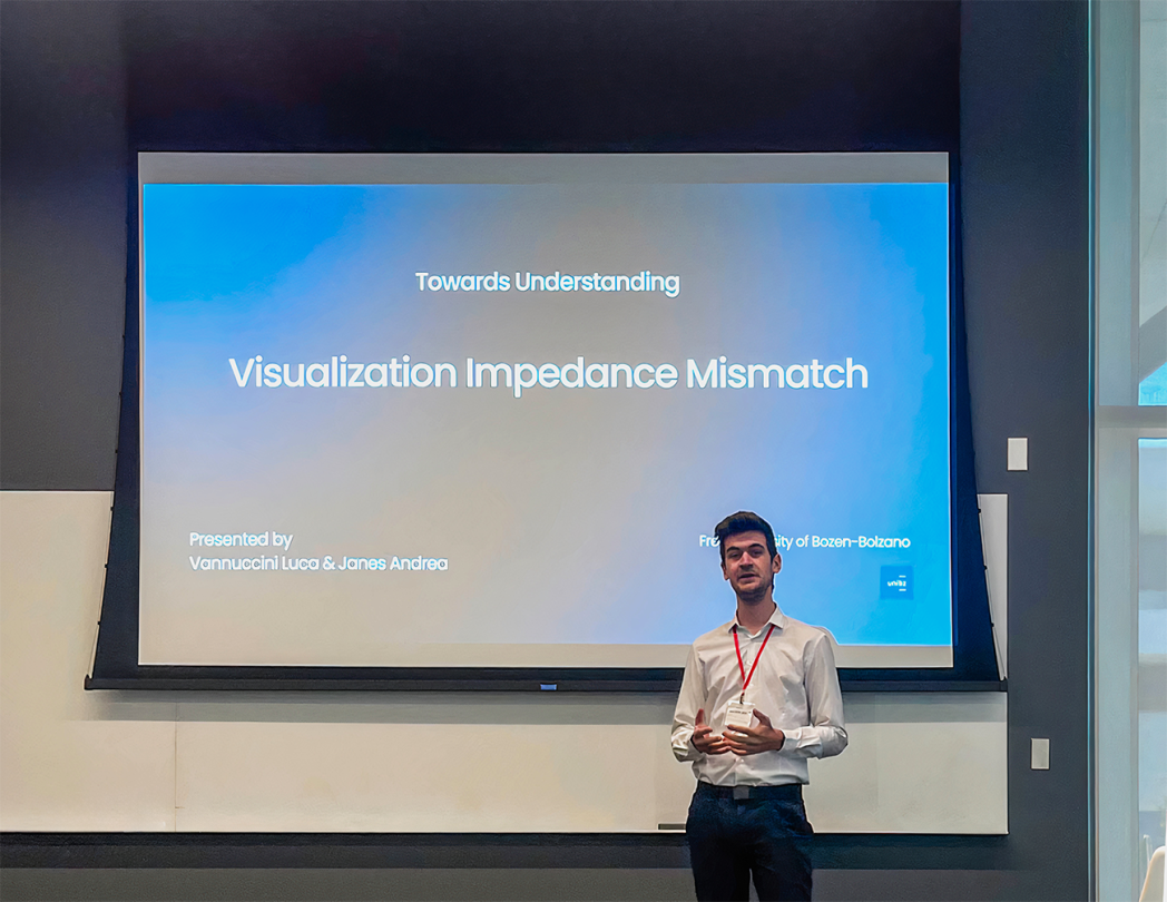 Man giving a presentation titled "Visualization Impedance Mismatch" in front of a large screen.