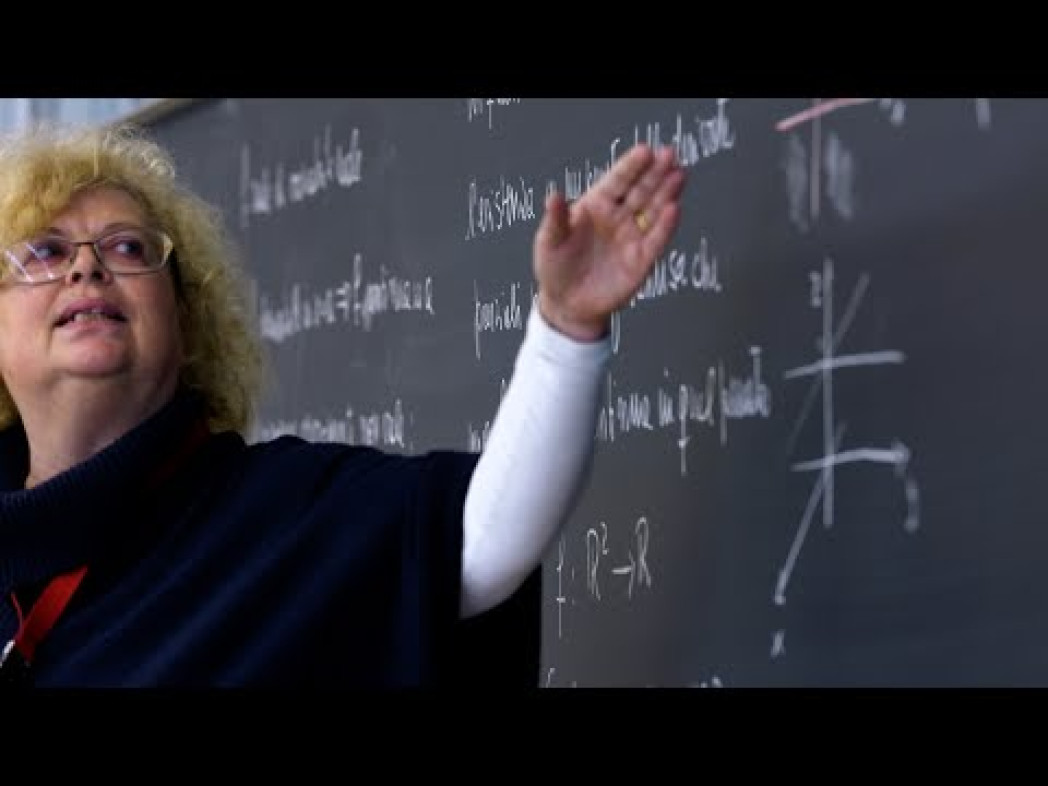 Woman pointing at something on a board