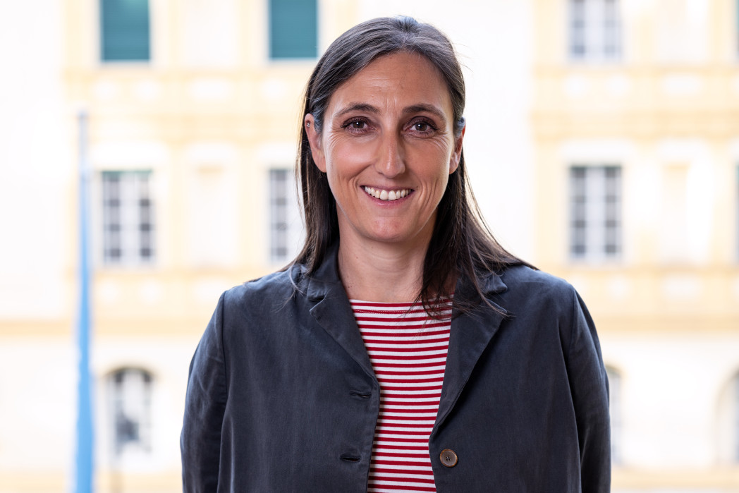 Woman in front of window with smile on face